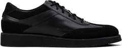 A pair of black suede leather semi-formal trainers with a lace-up closure and a thick sole.