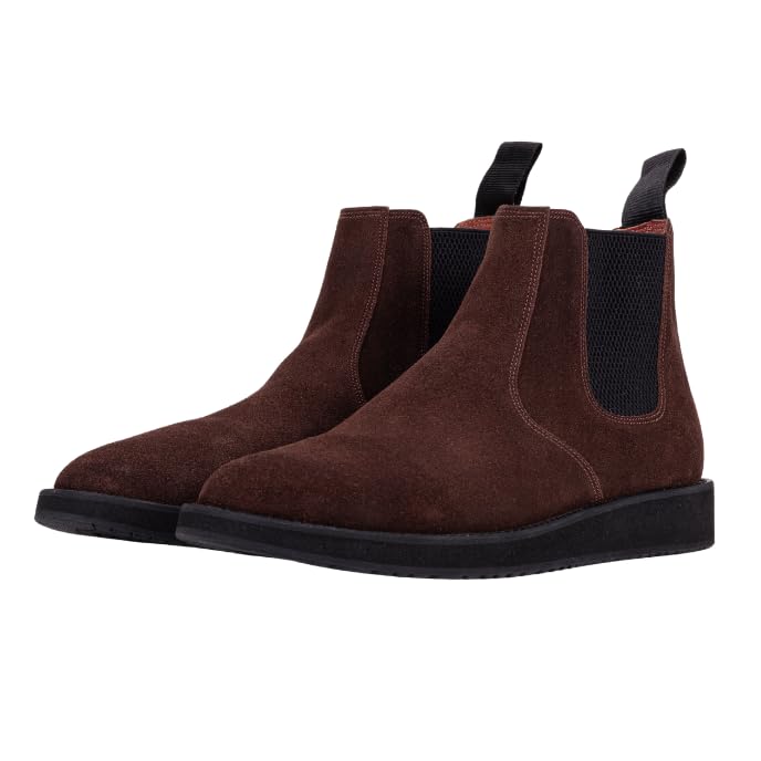 A pair of brown leather Chelsea boots with a rubber sole.