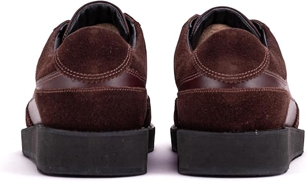 A pair of brown suede leather semi-formal trainers with a lace-up closure and a thick sole.