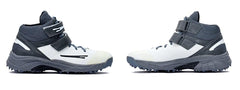A pair of white, and grey cricket bowling shoes with rubber studs and an external strap for support.