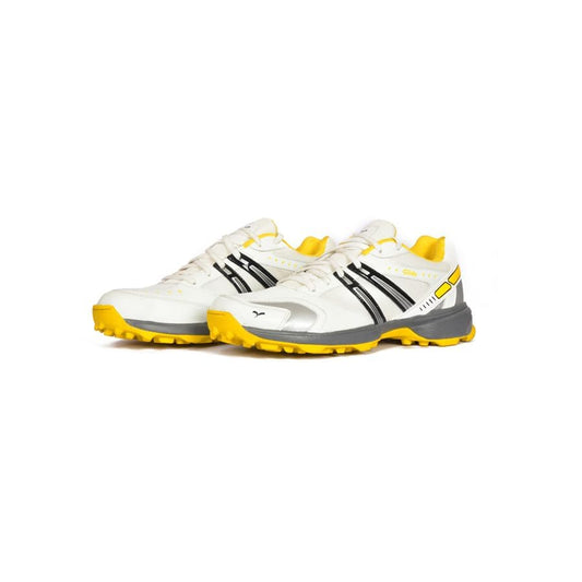 A pair of white cricket shoes with yellow accents and a distinctive design on the sole.