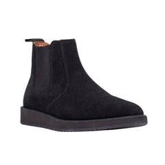 A pair of black leather Chelsea boots with a rubber sole.