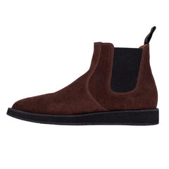 A pair of brown leather Chelsea boots with a rubber sole.