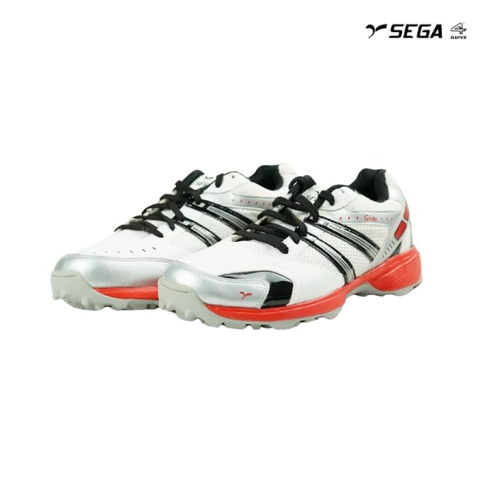 A pair of white cricket shoes with red accents and a distinctive design on the sole.