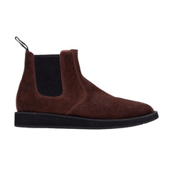 A pair of brown leather Chelsea boots with a rubber sole.