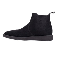 A pair of black leather Chelsea boots with a rubber sole.