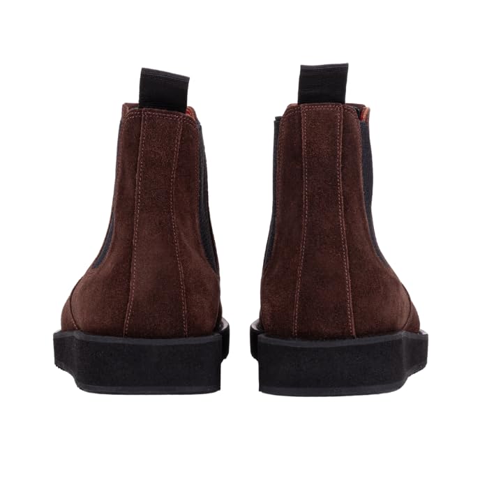 A pair of brown leather Chelsea boots with a rubber sole.