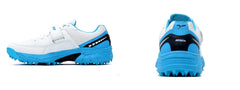 A pair of white, blue QUIVE SEGA REACH Performance Cricket Studs Boots with a synthetic and textile upper, featuring a midfoot band and a rubber outsole.