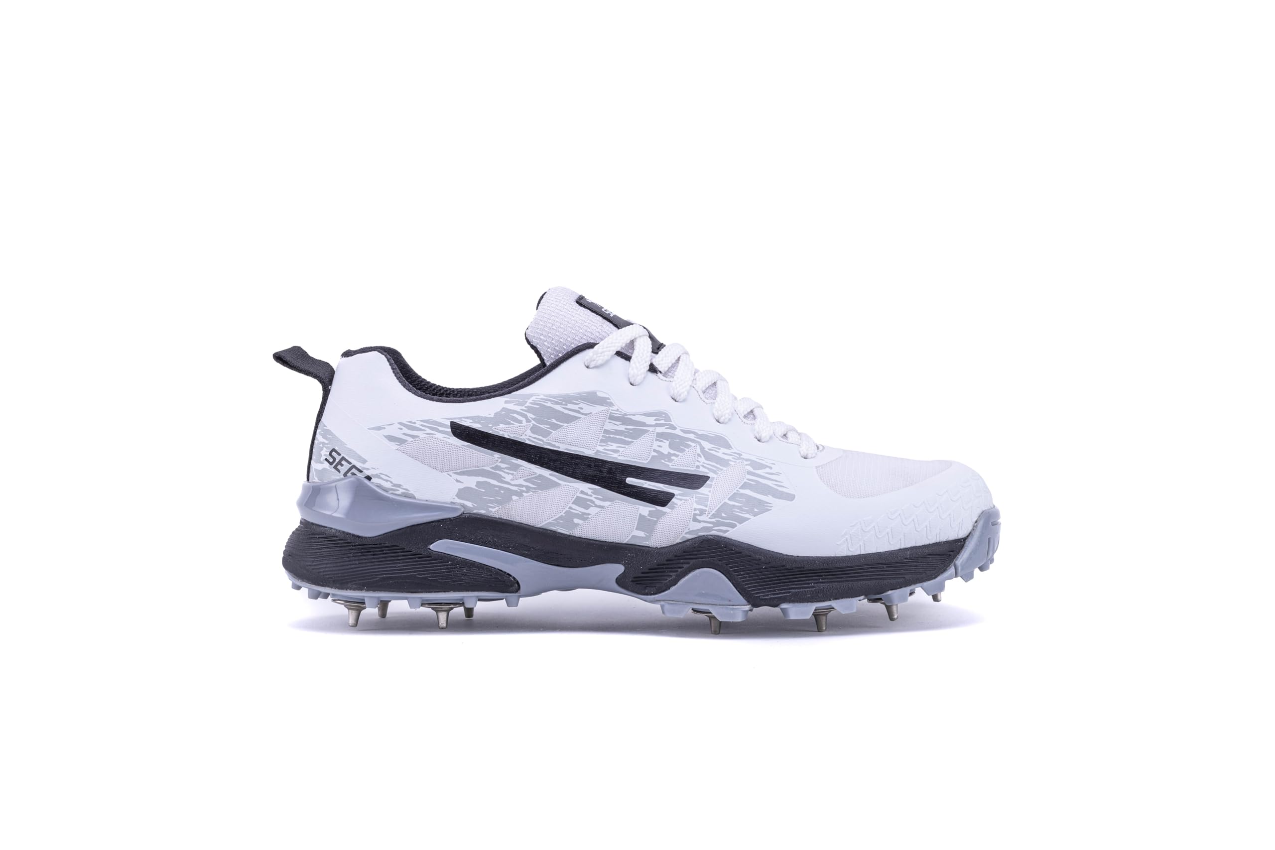 A pair of Sega Freedom men's cricket shoes featuring durable metal spikes and a white low-profile design with black accents.