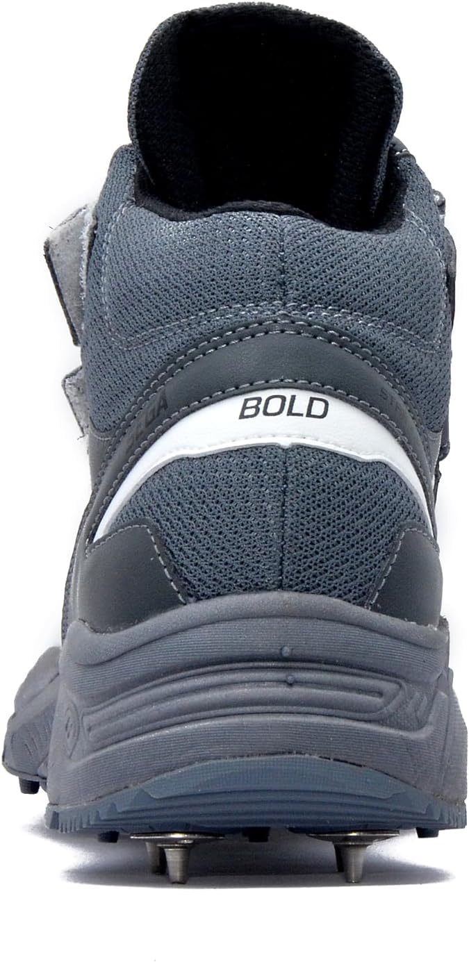 A pair of white, and grey cricket bowling shoes with metal spikes and an external strap for support.