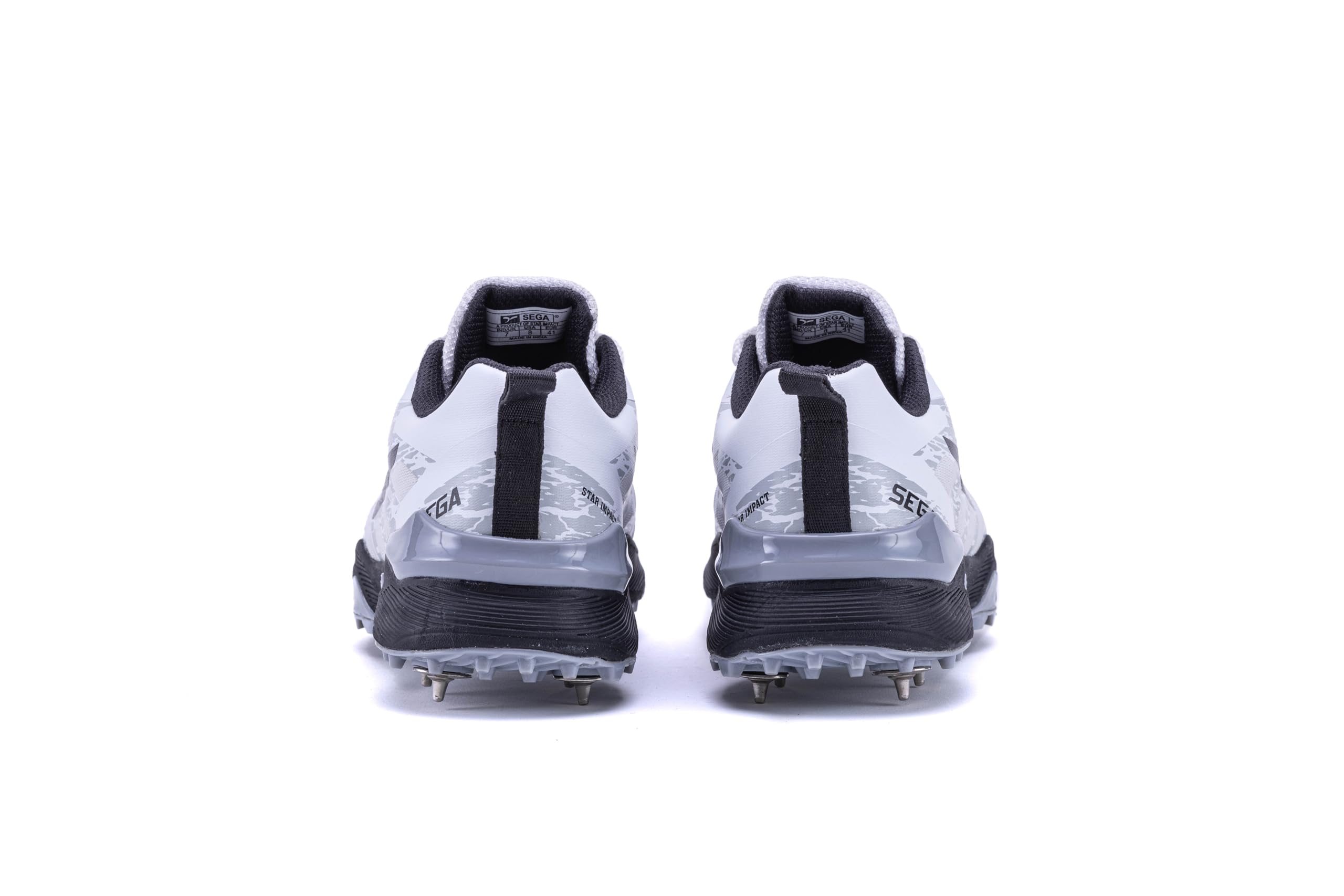 A pair of Sega Freedom men's cricket shoes featuring durable metal spikes and a white low-profile design with black accents.