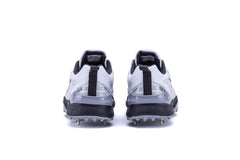 A pair of Sega Freedom men's cricket shoes featuring durable metal spikes and a white low-profile design with black accents.