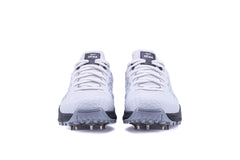 A pair of Sega Freedom men's cricket shoes featuring durable metal spikes and a white low-profile design with black accents.