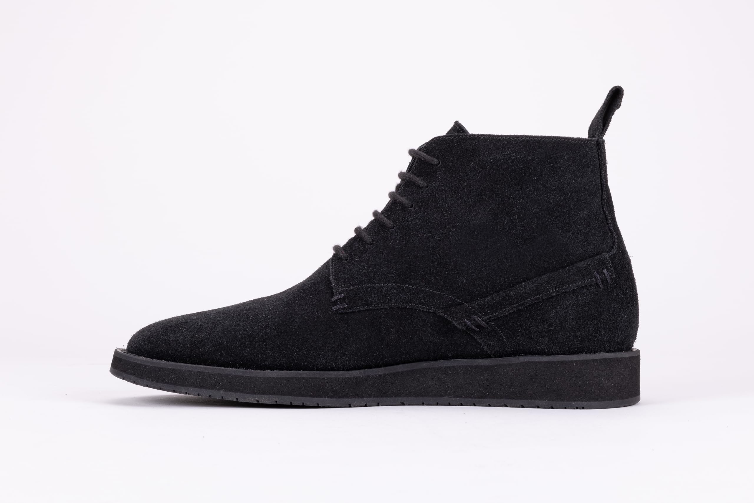 Pair of black suede high-top boots on a white background