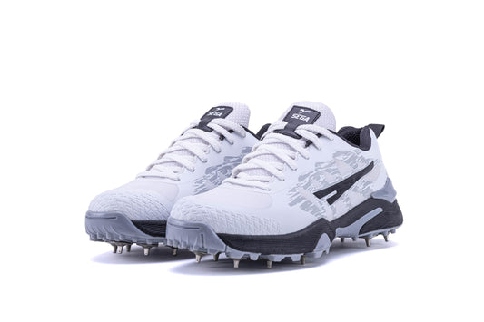 A pair of Sega Freedom men's cricket shoes featuring durable metal spikes and a white low-profile design with black accents.