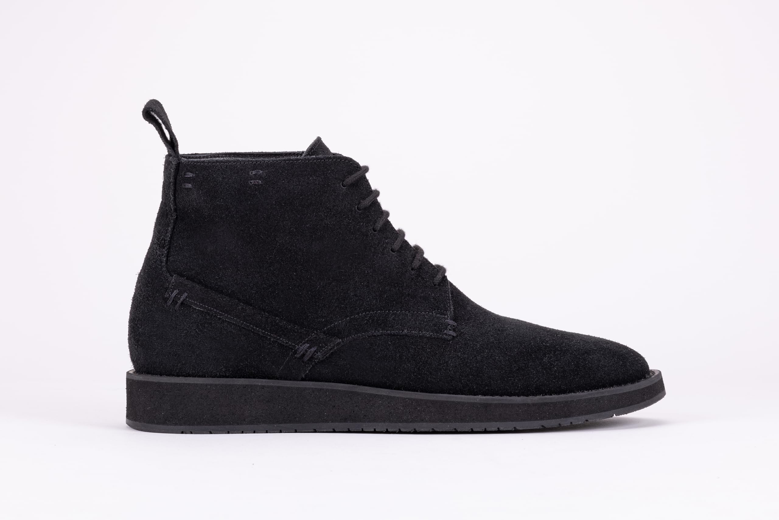 Pair of black suede high-top boots on a white background