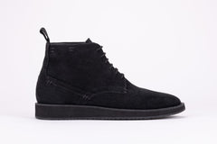 Pair of black suede high-top boots on a white background