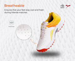 A pair of white, and orange cricket shoes with rubber studs and an lace up for support.