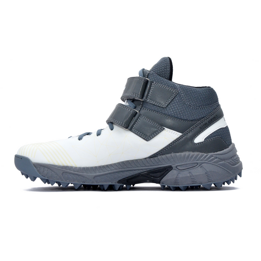 A pair of white, and grey cricket bowling shoes with rubber studs and an external strap for support.