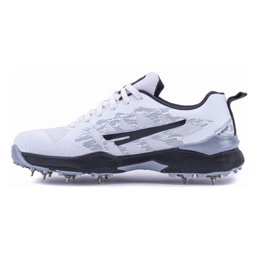 A pair of Sega Freedom men's cricket shoes featuring durable metal spikes and a white low-profile design with black accents.