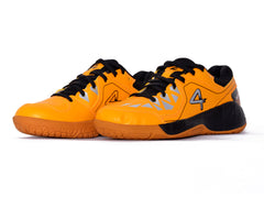 Yellow sports shoe with black accents on a white background, badminton, squash, tennis, table tennis