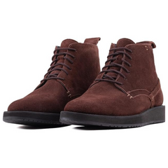 A pair of brown Quive London Chukka leather boots with a smooth texture and lace-up design.