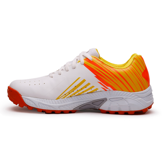 A pair of white, and orange cricket shoes with rubber studs and an lace up for support.