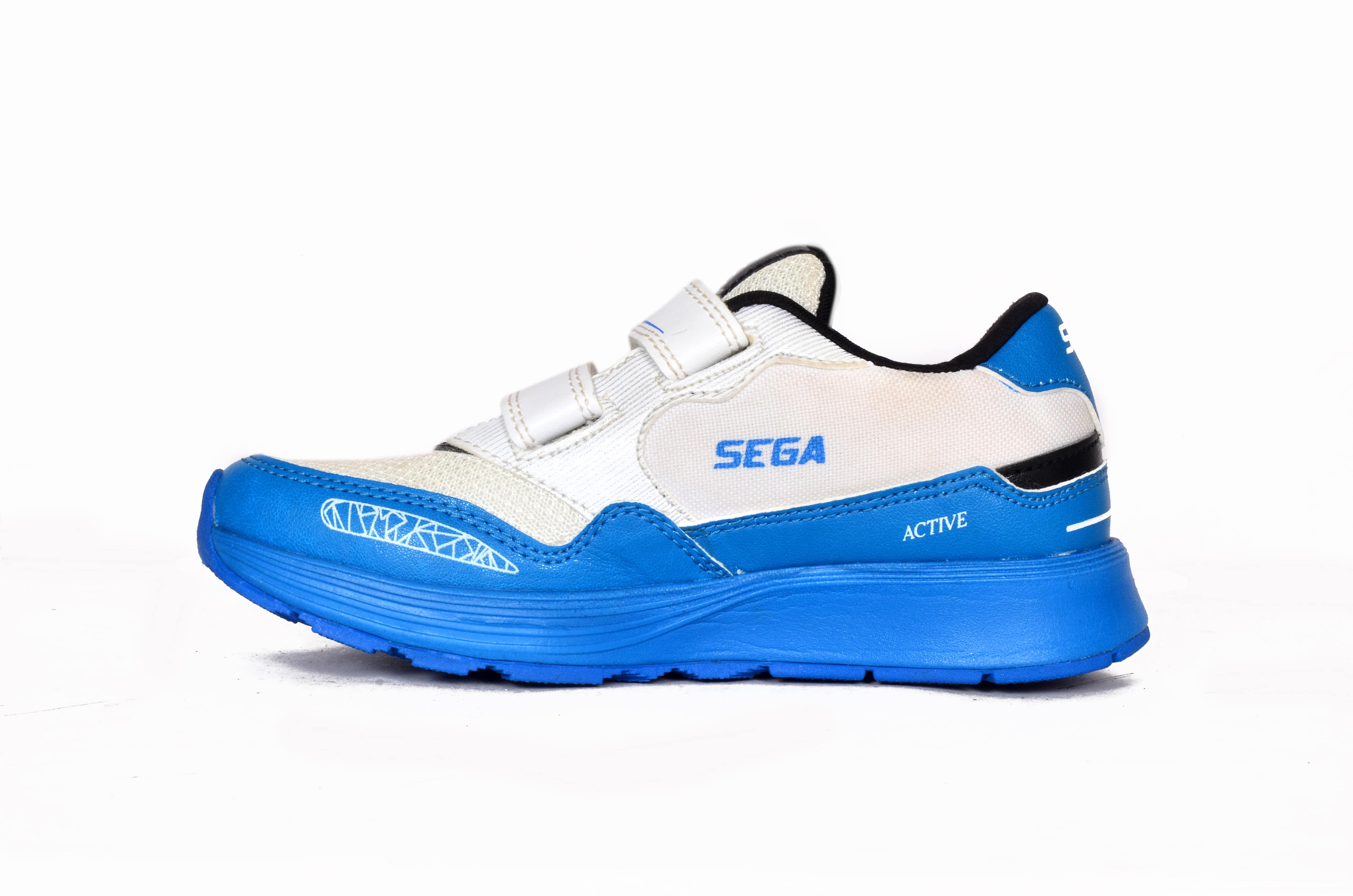 white, blue, black, two toned, kids, children, boys shoes, children's shoes, children's trainers, kids shoes, kids trainers, for kids, for trainers, for kids, multicoloured, multicolored, SEGA SHOES, SEGA SPORTS, SEGA ACTIVE , Image of SEGA Active in its blue & white variation facing left of the camera,