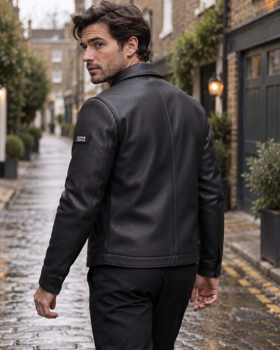 Man wearing the SLOANE black leather jacket from the rear in a London mews