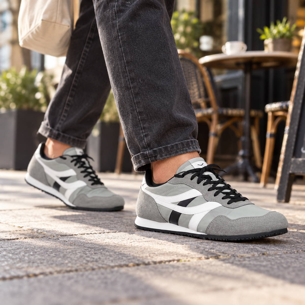 Grey SEGA men's suede leather trainers worn at a cafe terrace