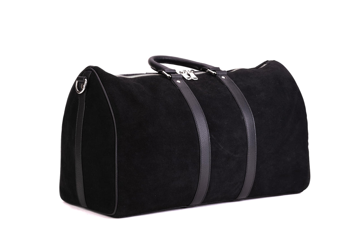 Black QUIVE London Fitzrovia suede weekender bag in a side three-quarter view
