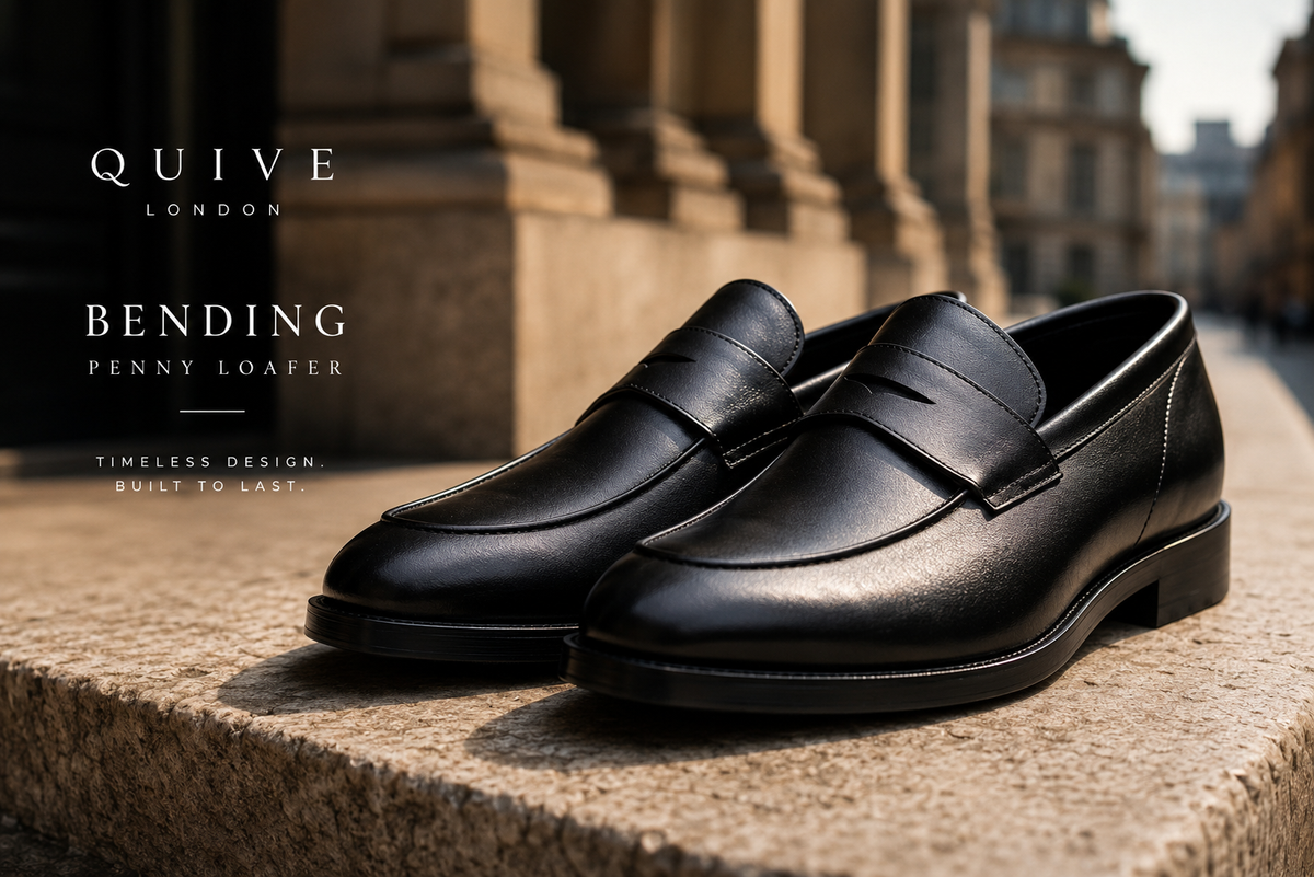 QUIVE London Bending black leather penny loafers worn with business tailoring