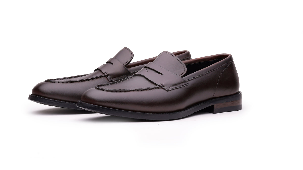 Brown QUIVE London Perth leather penny loafers in a front three-quarter view