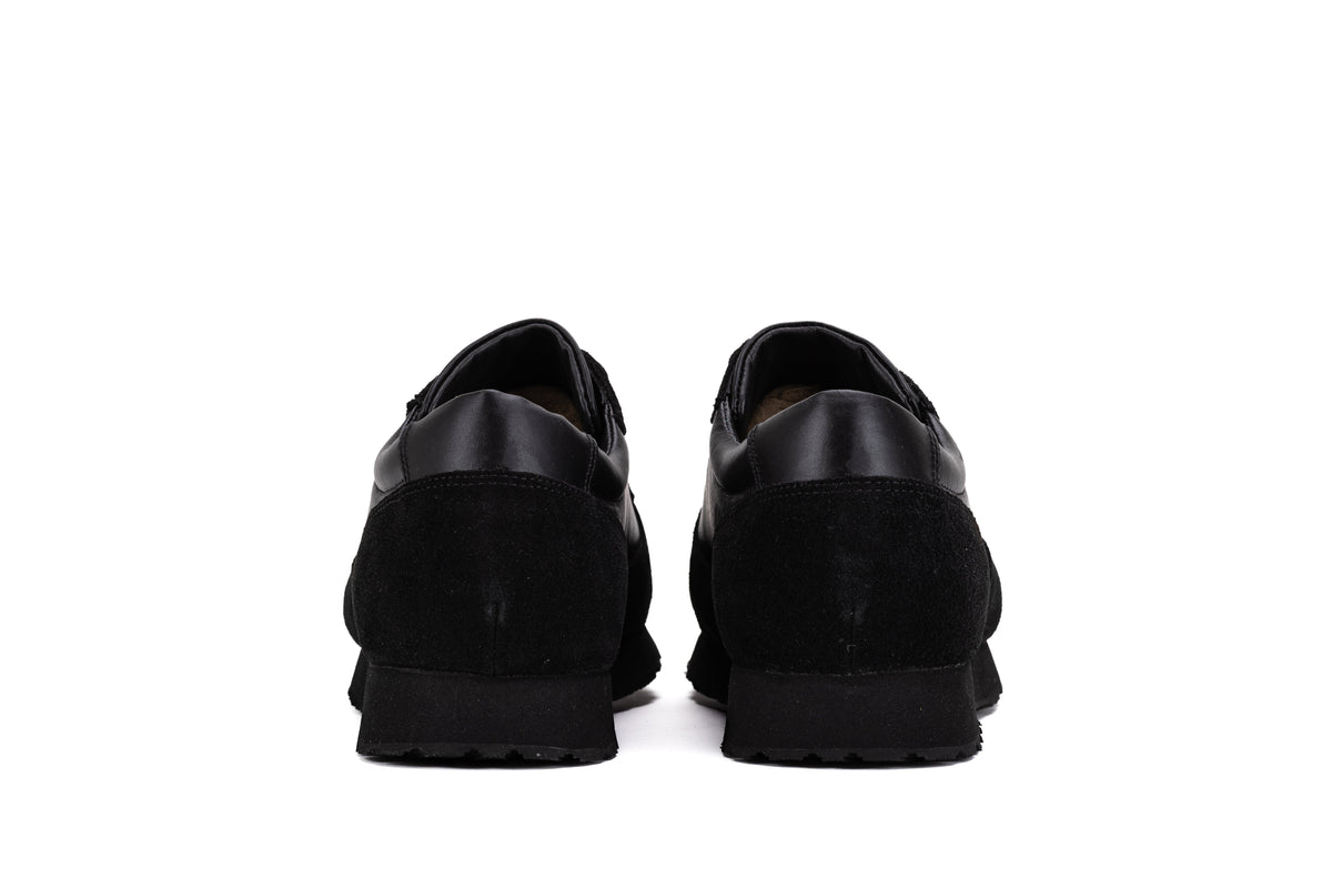Black QUIVE London Belgravia leather trainers, heel view