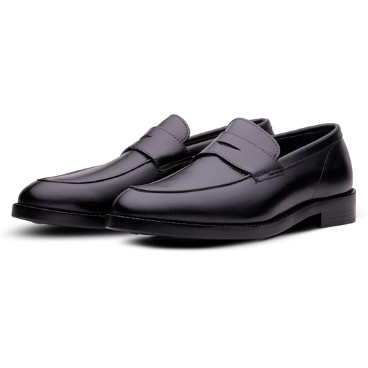 A pair of men's black leather penny loafers with a low stacked heel, shown from a three-quarters angle on a white background.
