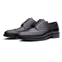 Pair of black leather oxford work and dress shoes on a white background