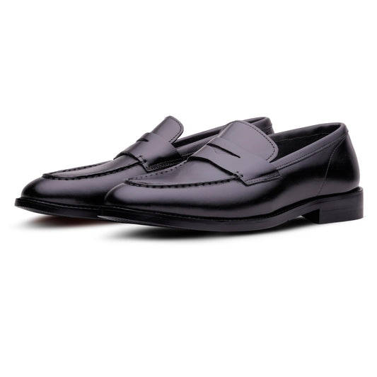 Pair of black loafers on a white background