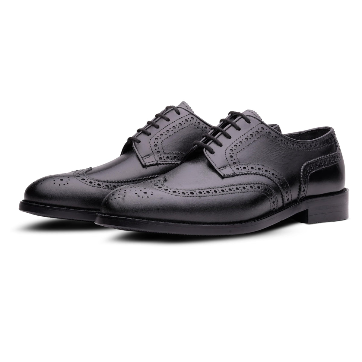 Pair of QUIVE London Kensington black leather wingtip Derby shoes on a white background