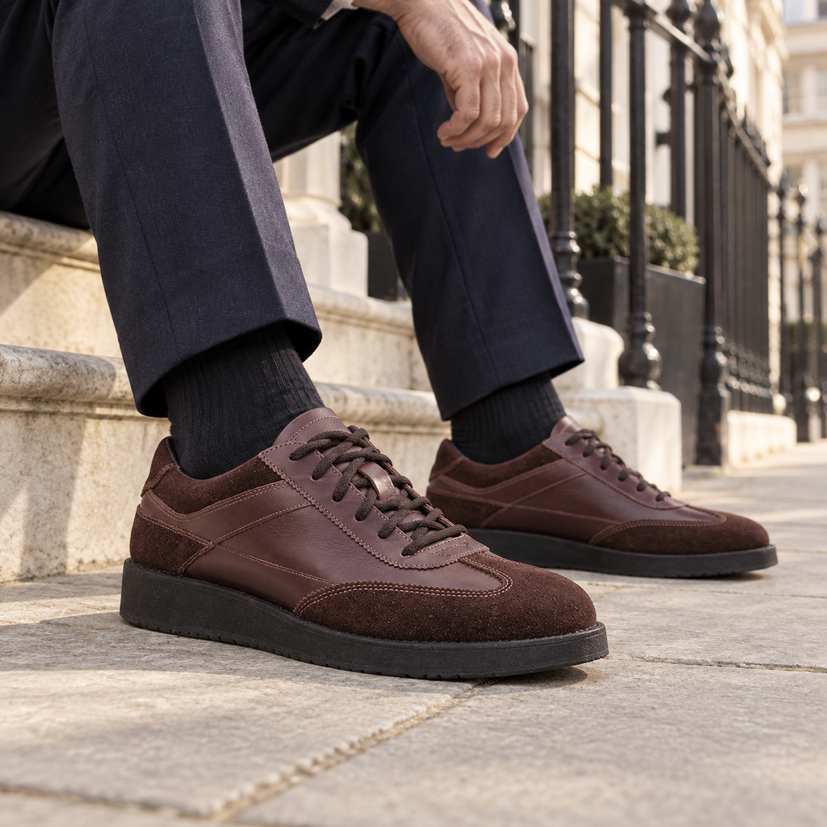 QUIVE London Richmond brown leather trainers worn in a natural city setting