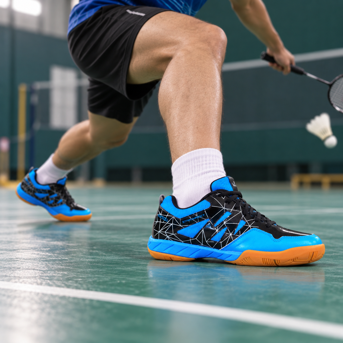 Blue QUIVE Lotus court shoes worn during a badminton lunge