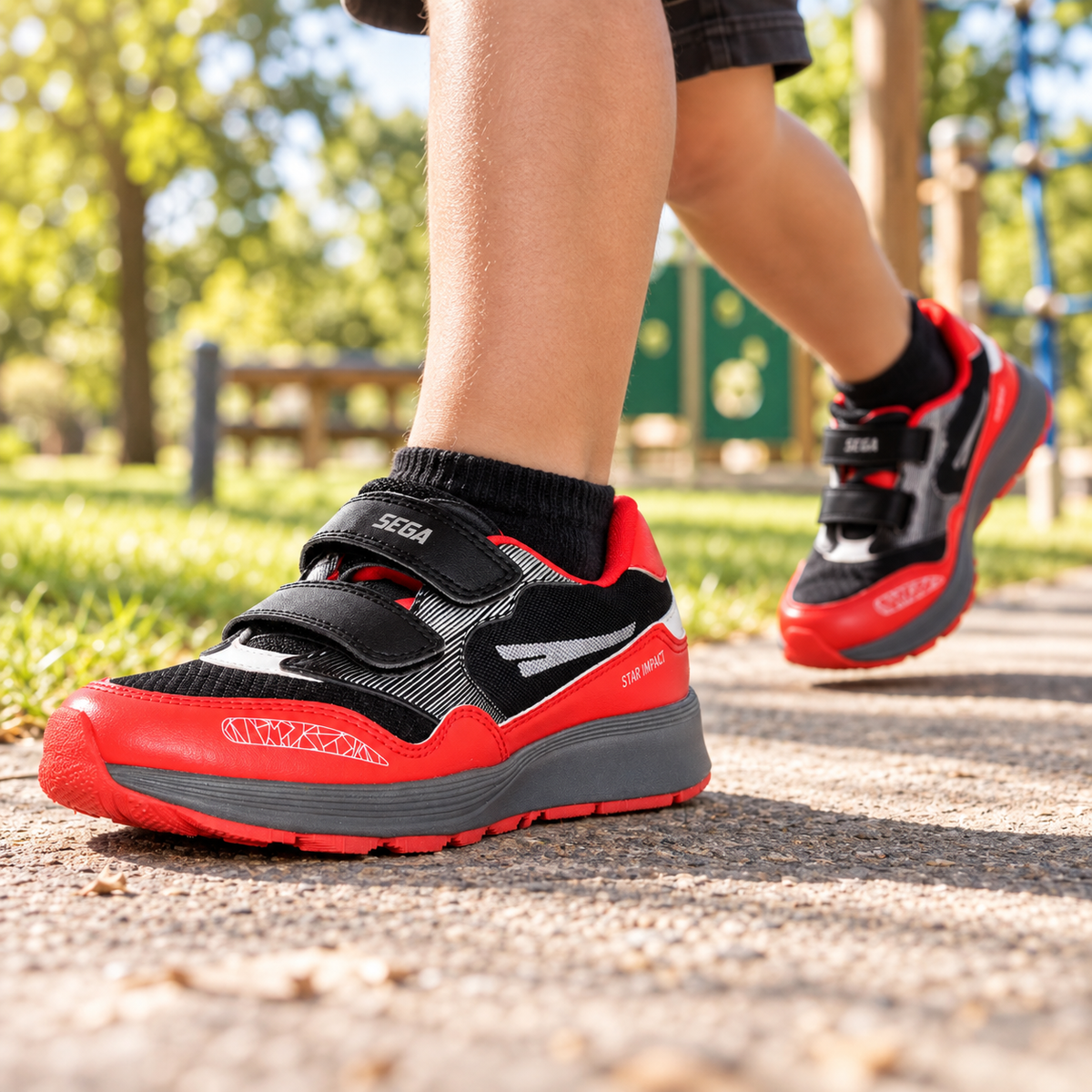 Black and red SEGA Active kids trainers worn during outdoor park play