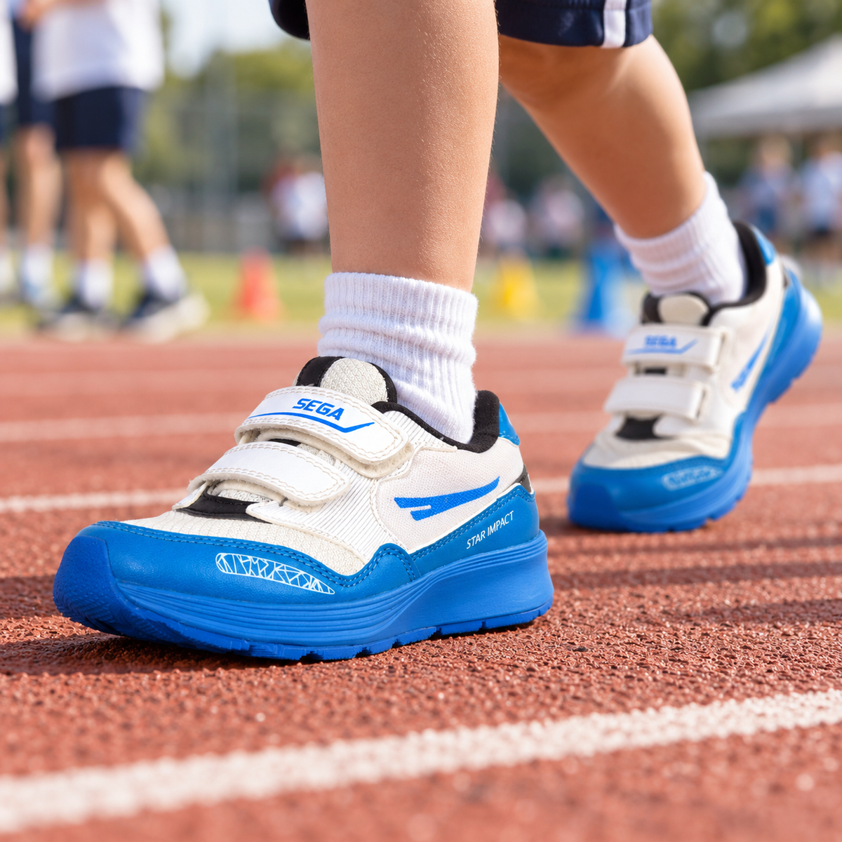 White and blue SEGA Active kids trainers worn at a school sports day